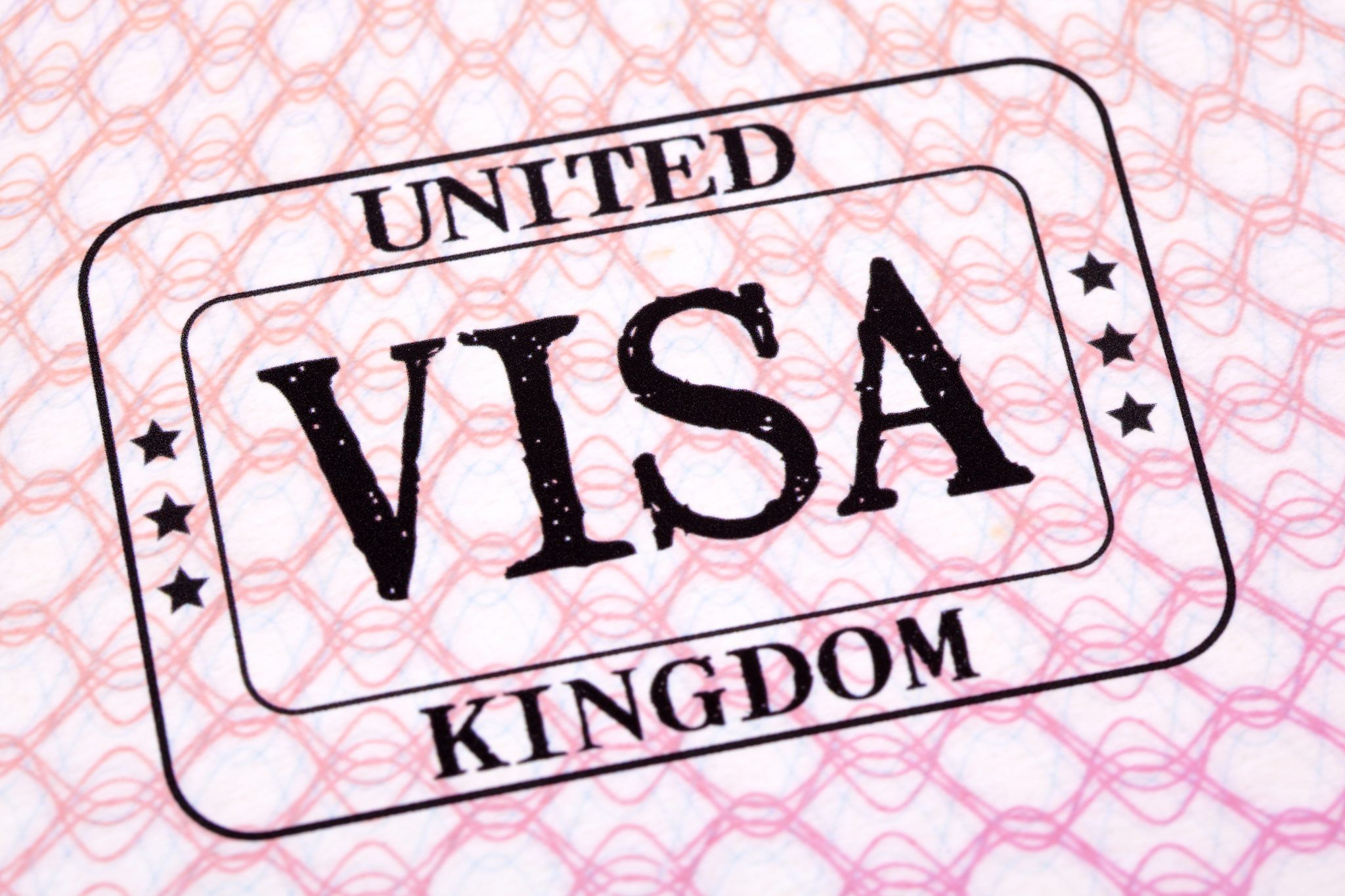UK visa immigration stamp passport page close up